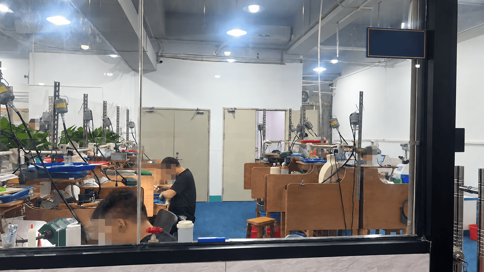 Representative jewelry production workshop with worker faces pixelated for privacy